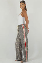 Women's leopard print wide leg jeans with white stripe and red hearts