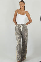 Women's leopard print wide leg jeans with beige racer stripes
