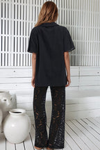 Women's black two piece set with collared shirt and sheer lace trousers
