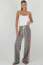 Women's leopard print wide leg jeans with white stripe and red hearts