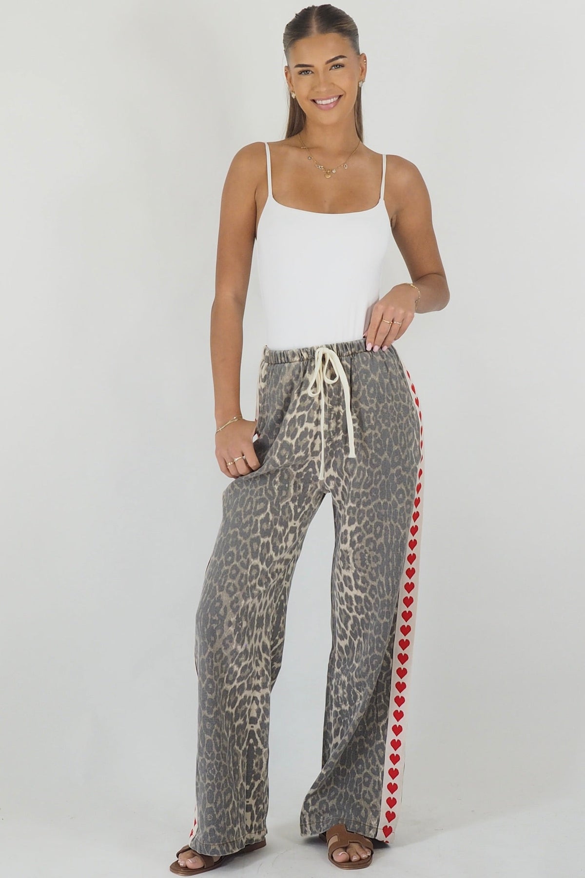 Women's leopard print wide leg jeans with white stripe and red hearts
