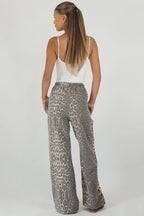 Women's leopard print wide leg jeans with white stripe and red hearts