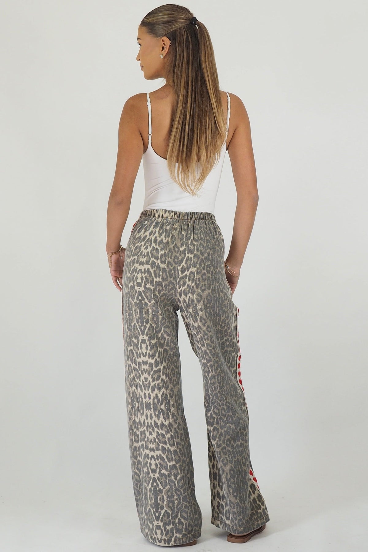Women's leopard print wide leg jeans with white stripe and red hearts