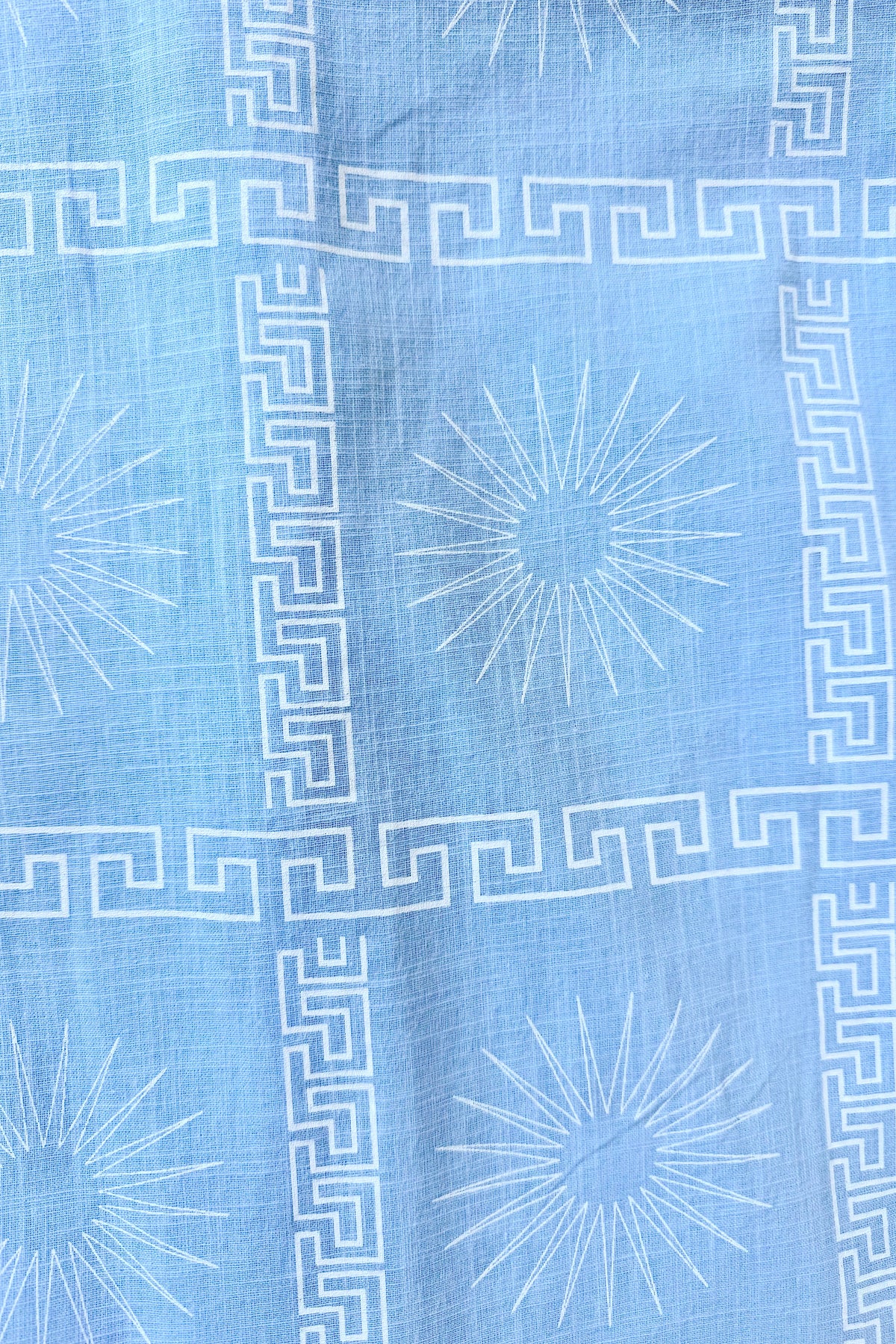 Women's blue cotton playsuit with white abstract sun print