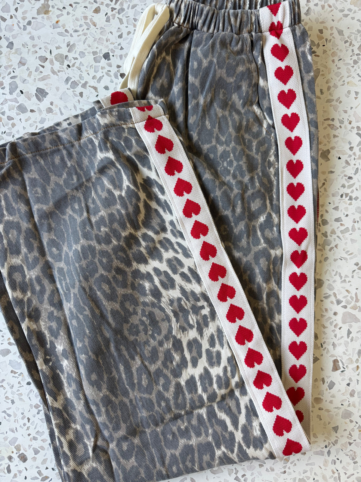 Women's leopard print wide leg jeans with white stripe and red hearts