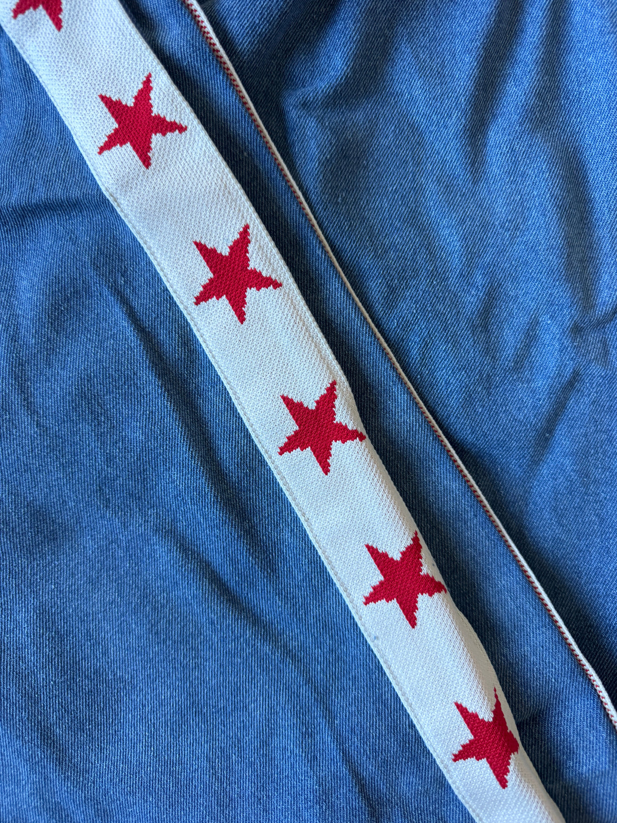 Women's denim wide leg jeans with white racer stripe and red stars