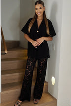 Women's black two piece set with collared shirt and sheer lace trousers