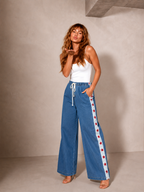 Women's denim wide leg jeans with white racer stripe and red stars