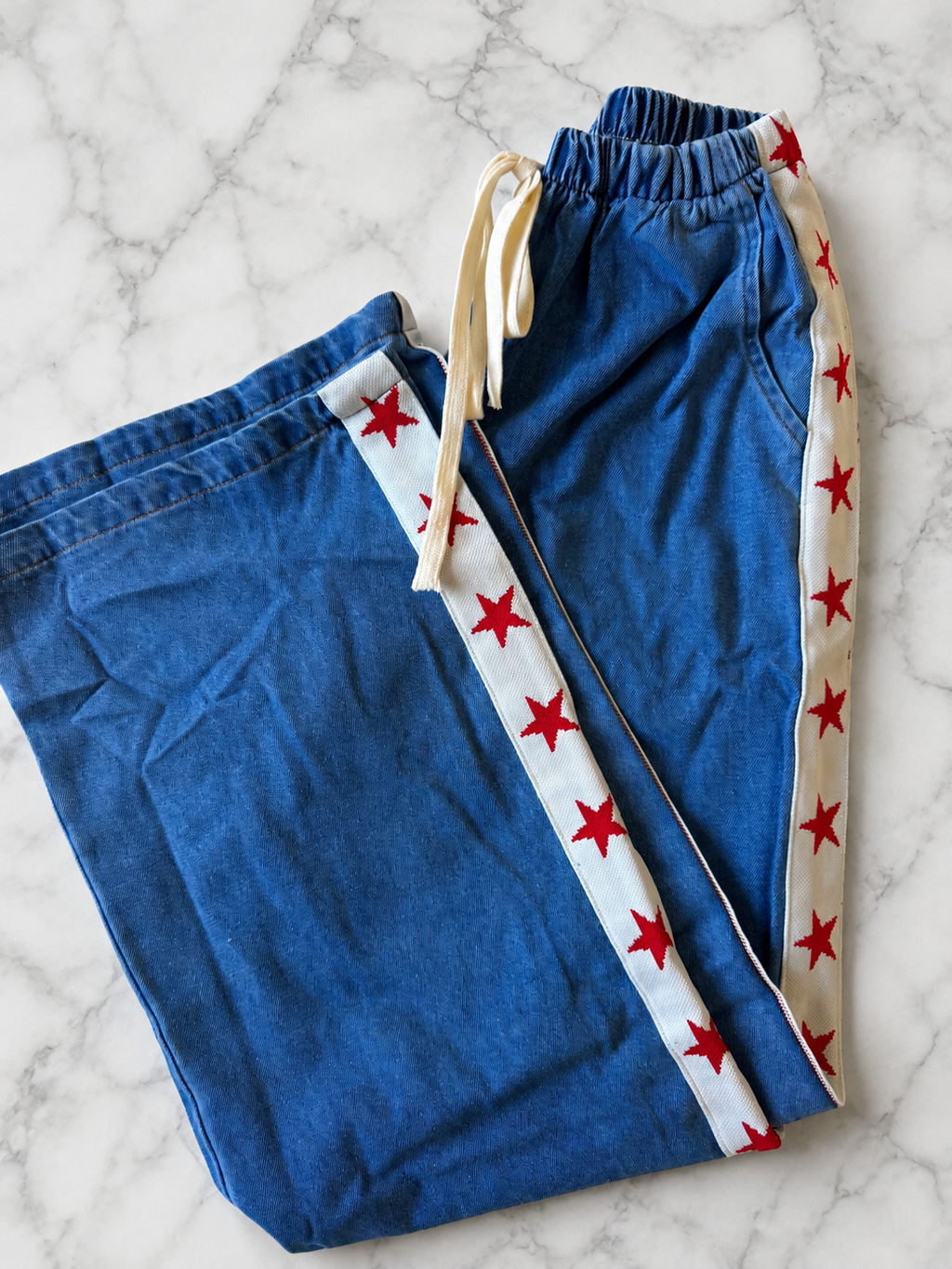 Women's denim wide leg jeans with white racer stripe and red stars