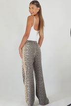 Women's leopard print wide leg jeans with beige racer stripes