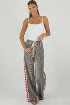 Women's leopard print wide leg jeans with white stripe and red hearts