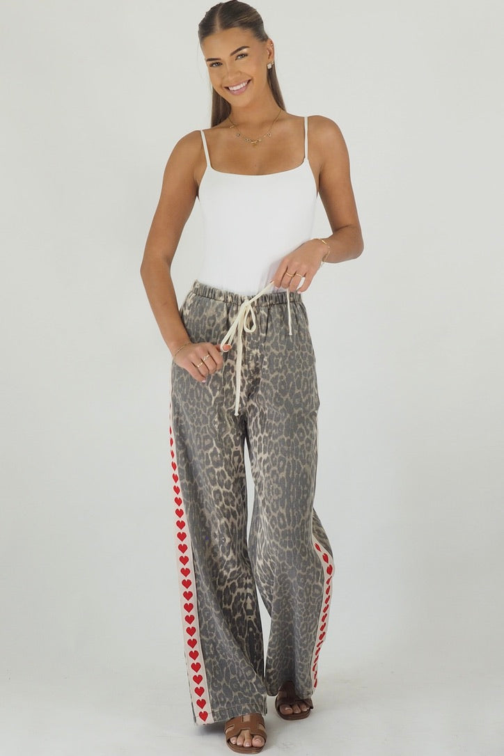 Women's leopard print wide leg jeans with white stripe and red hearts