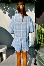 Women's blue cotton playsuit with white abstract sun print