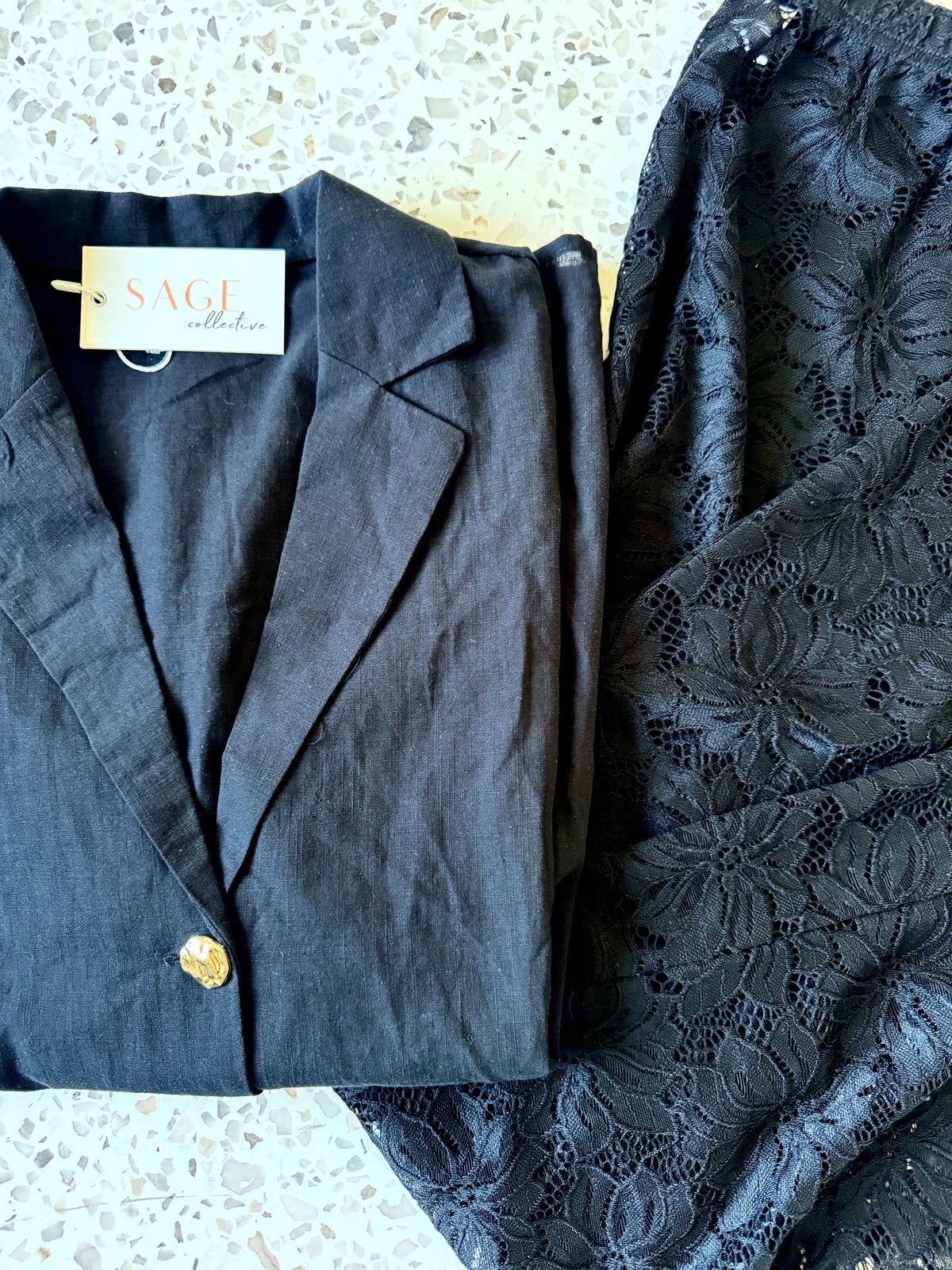 Women's black two piece set with collared shirt and sheer lace trousers