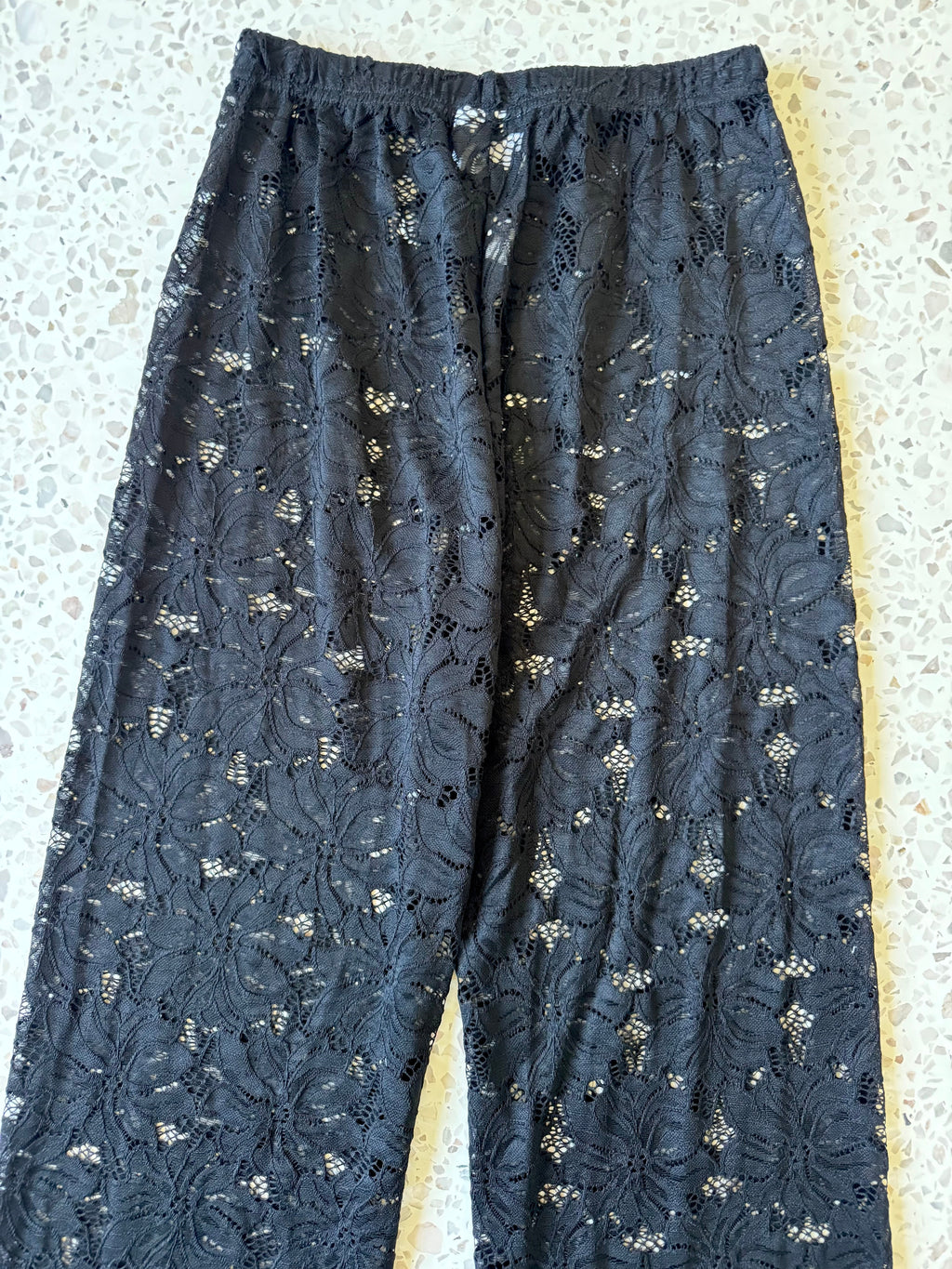 Women's black two piece set with collared shirt and sheer lace trousers