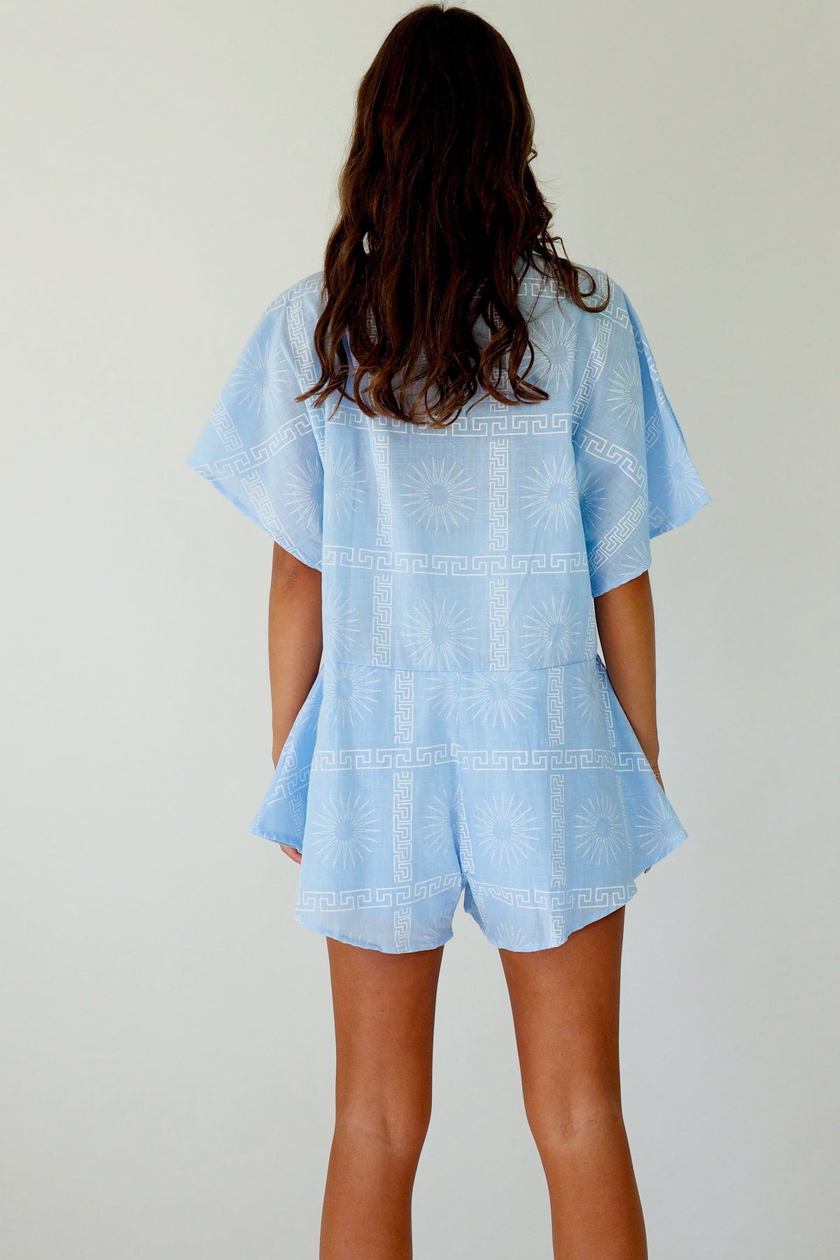 Women's blue cotton playsuit with white abstract sun print
