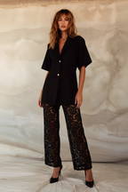 Women's black two piece set with collared shirt and sheer lace trousers